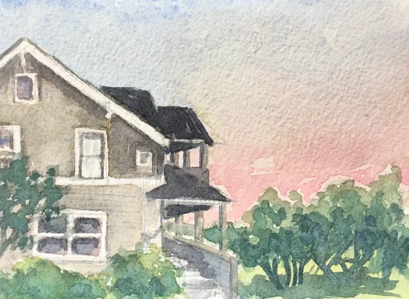 Watercolor painting of a house with a sloped roof and porch, surrounded by bushes, with a pinkish sky in the background.