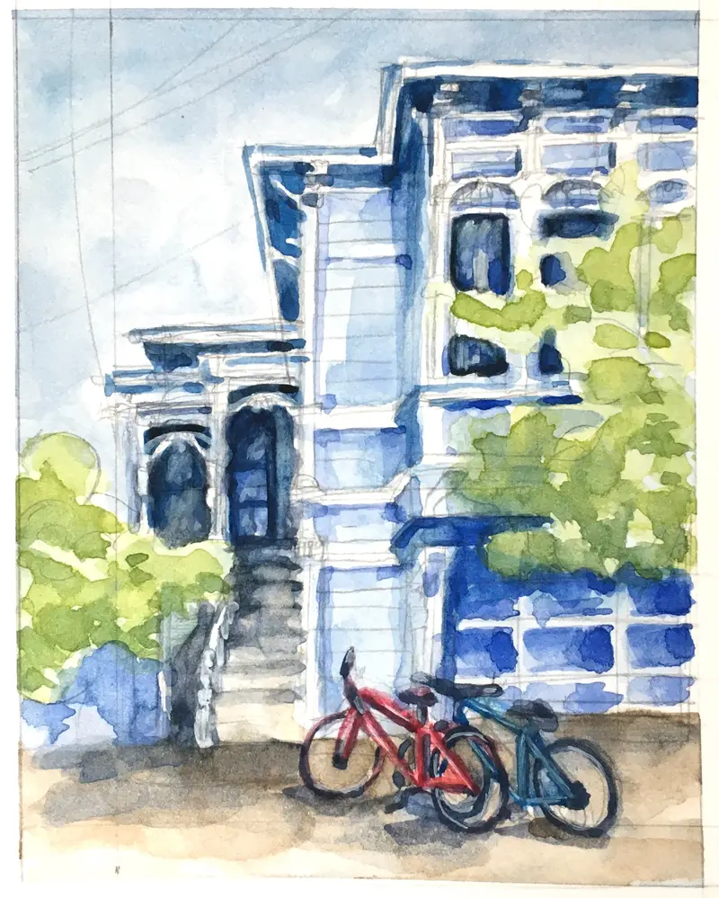 Watercolor house portrait of a beloved blue Victorian house in San Francisco. The house has arched windows, is surrounded by greenery, and has two bicycles in the foreground.