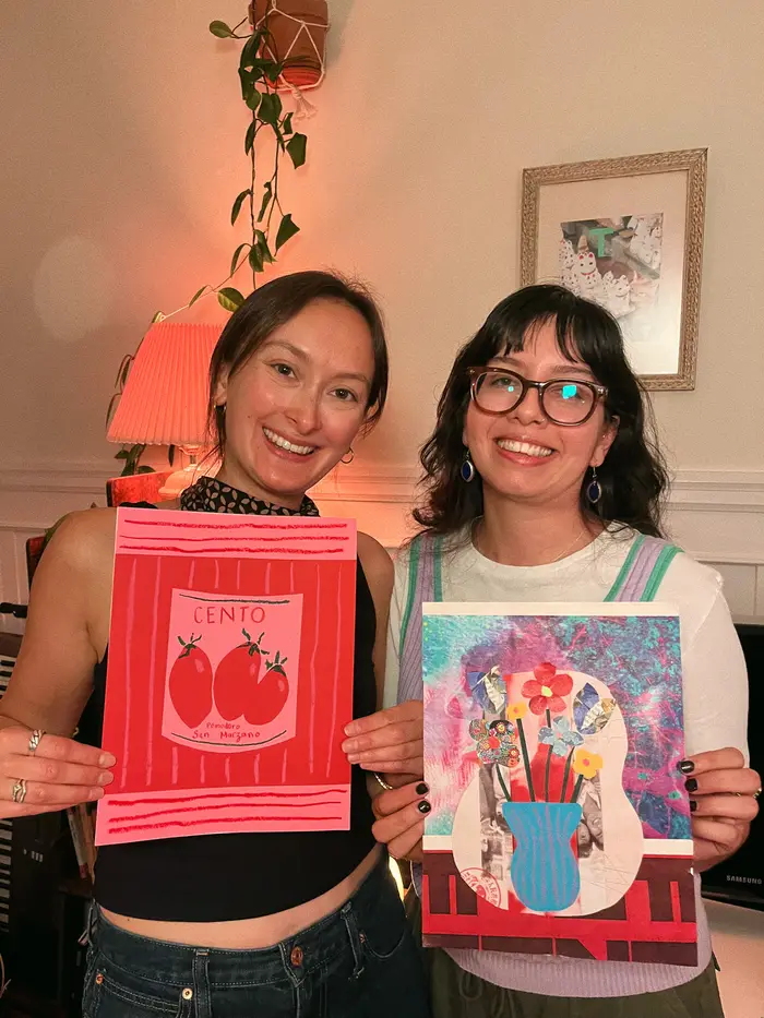 Two smiling artists holding colorful still life collages of tomatoes and flowers.